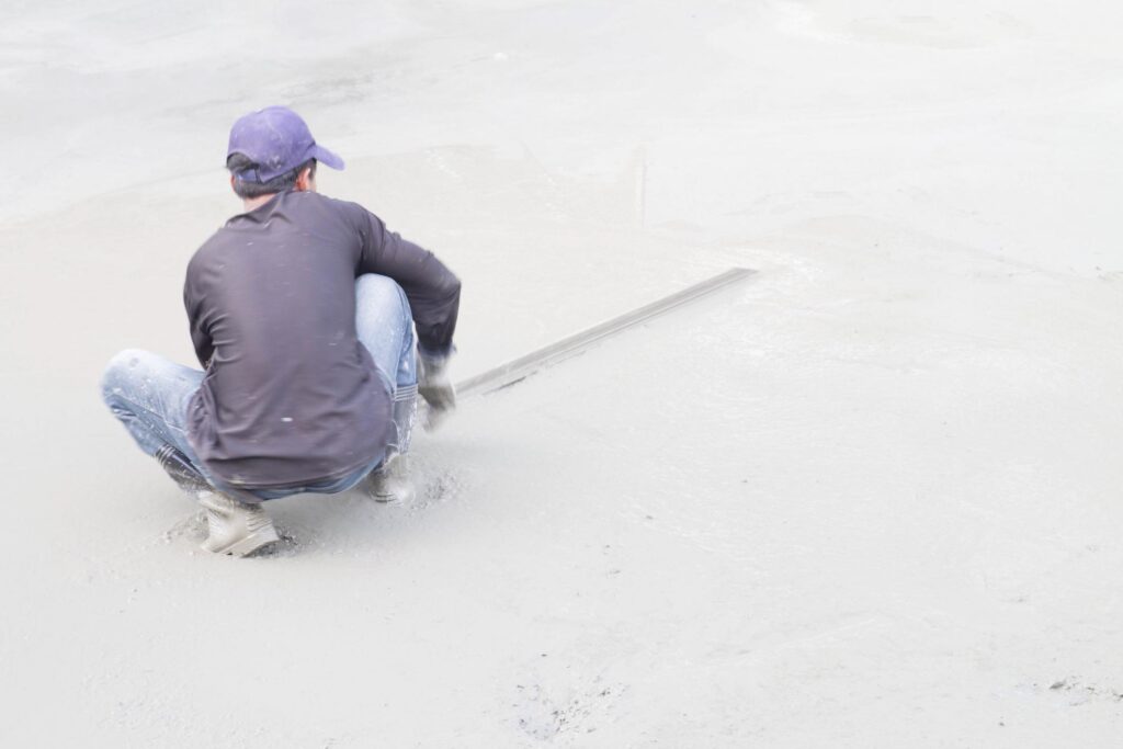 Concrete Finishing Bryan-College Station TX - Concrete Repair Rehab 1 a man sitting on the beach with his feet in the sand