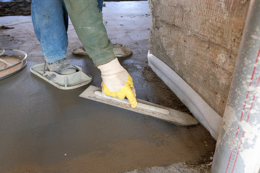 workers poured concrete into a wooden formwork